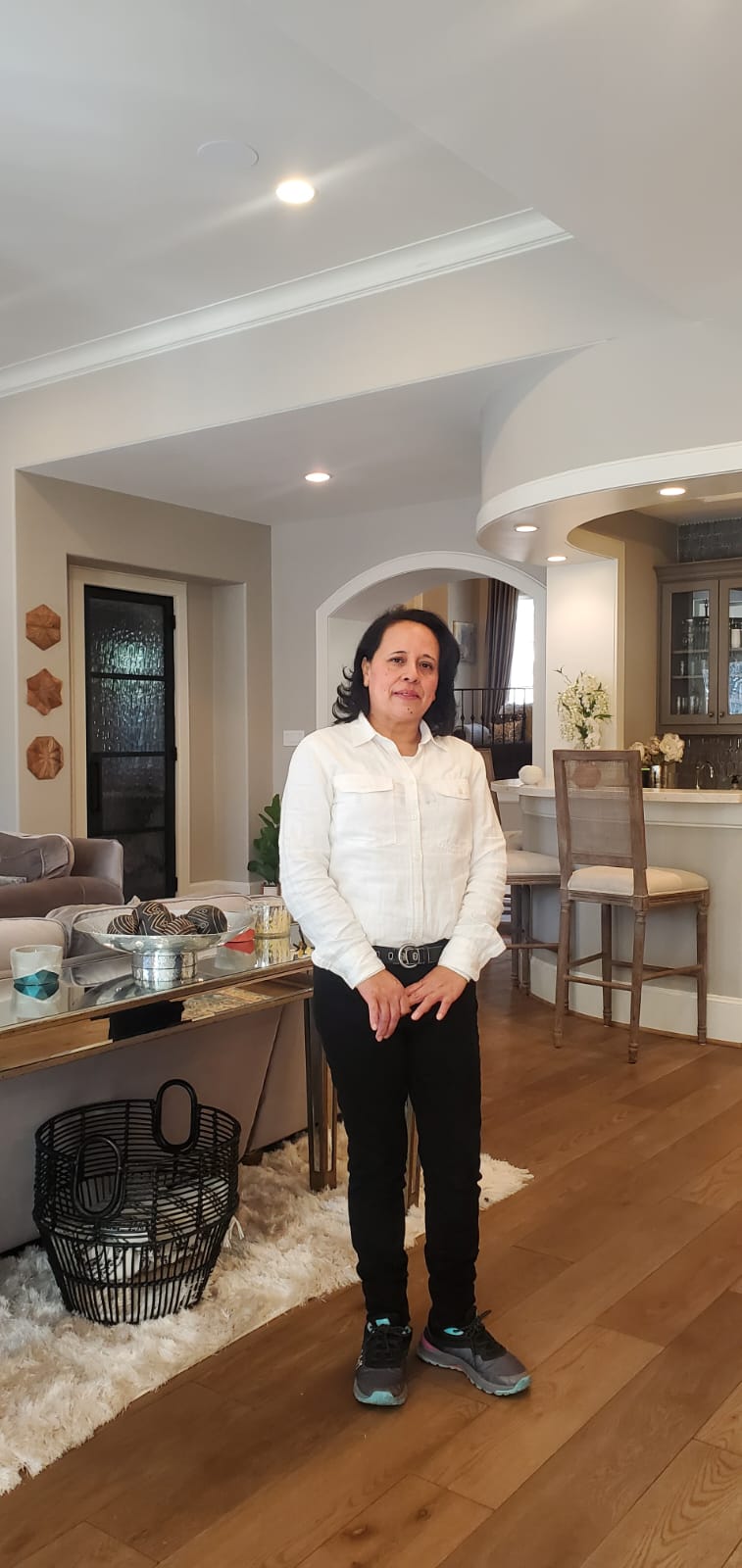 Glory Clean team member standing in a client's living room in Houston, TX